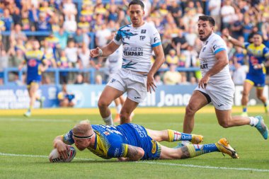 Oliver Holmes #12 of Warrington Wolves scores a try