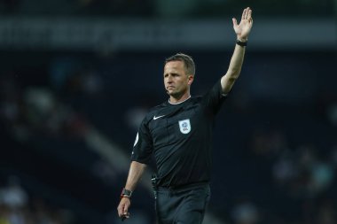 Referee David Webb points to give a corner kick