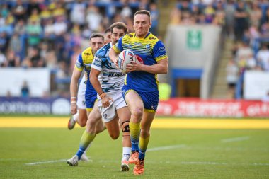 Ben Currie #11 of Warrington Wolves makes a break