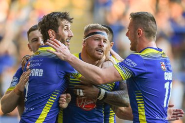 Oliver Holmes #12 of Warrington Wolves celebrates his try