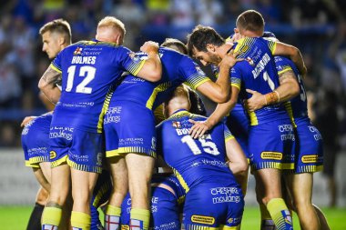 George Williams #7 of Warrington Wolves celebrates his try with team mates