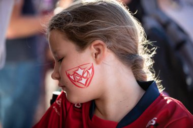 A young Hull KR supporter gets the Hull KR badge painted on her face for this evenings game  