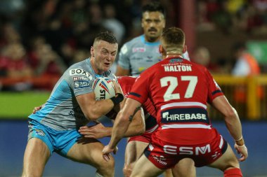 Harry Newman #3 of Leeds Rhinos is tackled by the Hull KR defence