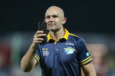 Rohan Smith Head Coach of Leeds Rhinos videos the singing travelling fans at the end of the match