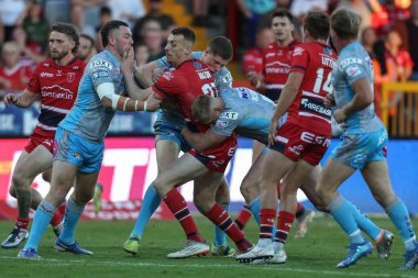 Frankie Halton #27 of Hull KR is stopped by the Leeds defence