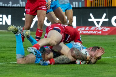 Richie Myler #16 of Leeds Rhinos is hurt by Ethan Ryan #23 of Hull KR as he goes over for his second try of the evening 