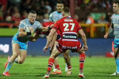 Harry Newman #3 of Leeds Rhinos is tackled by the Hull KR defence