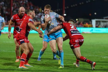 Morgan Gannon #21 of Leeds Rhinos is tackled by Frankie Halton #27 of Hull KR  
