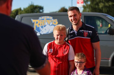 Matt Parcell #9 of Hull KR has a photo taken with a young fan
