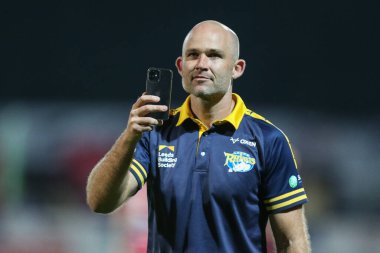 Rohan Smith Head Coach of Leeds Rhinos videos the singing travelling fans at the end of the match