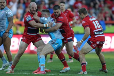 Harry Newman #3 of Leeds Rhinos is tackled by George King #10 and Matty Storton #13 of Hull KR  
