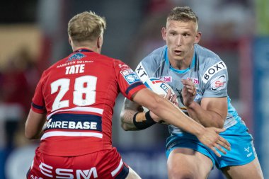 Mikolaj Oledzki #8 of Leeds Rhinos is tackled by Will Tate #28 of Hull KR 