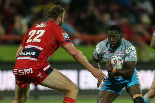 Muizz Mustapha #27 of Leeds Rhinos runs at Will Maher #22 of Hull KR 