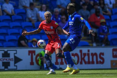 Juninho Bacuna #7 of Birmingham City  and Cdric Kipr #23 of Cardiff City  compete for the ball 