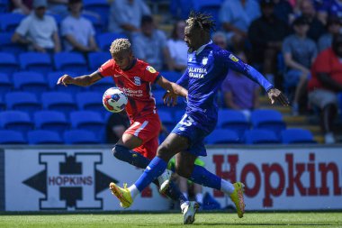 Juninho Bacuna #7 of Birmingham City  and Cdric Kipr #23 of Cardiff City  compete for the ball 