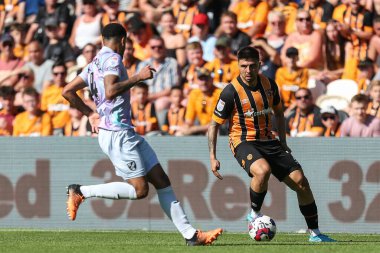 Ozan Tufan #7 of Hull City looks to go past Andrew Omobamidele #4 of Norwich City 