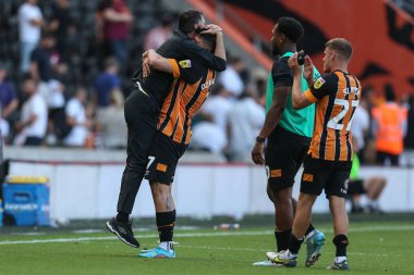 Ozan Tufan #7 of Hull City picks up Shota Arveladze manager of Hull City 