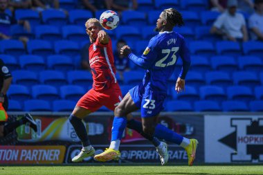 Todd Cantwell #14 of Norwich City and Tobias Figueiredo #6 of Hull City challenge for the ball   