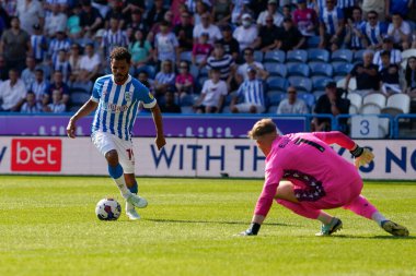 Sorba Thomas #7 of Huddersfield Town commits Josef Bursik #1 of Stoke City to set up their third goal