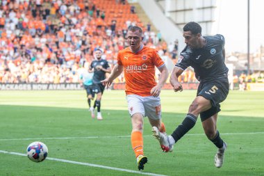 Shayne Lavery #19 of Blackpool puts pressure on Ben Cabango #5 of Swansea City as he clears the ball