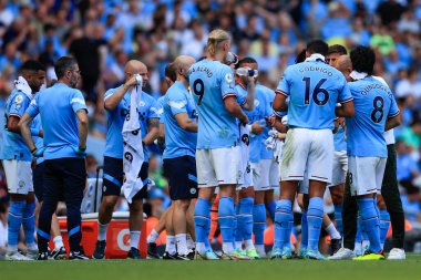 Manchester City players have a drinks break half way through the first half
