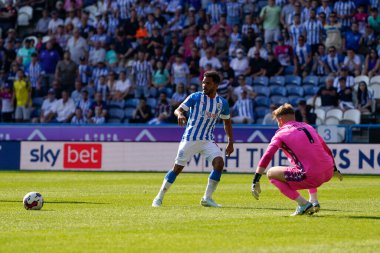 Sorba Thomas #7 of Huddersfield Town commits Josef Bursik #1 of Stoke City to set up their third goal