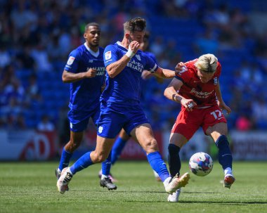 Przemys?aw P?acheta #17 of Birmingham City  shoots at goal, Under pressure from Ryan Wintle #6 of Cardiff City  