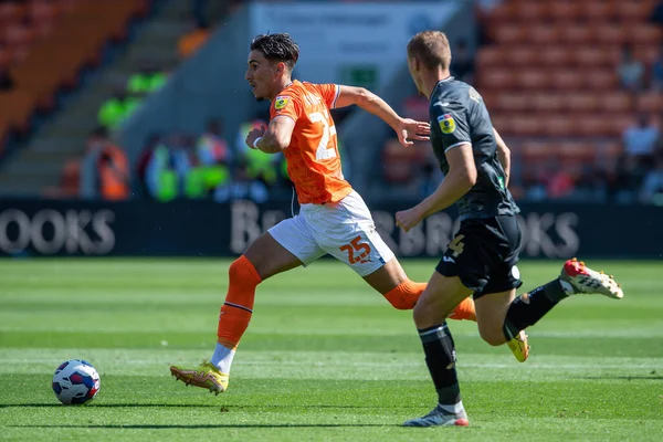 Theo Corbeanu #25 of Blackpool makes a break with the ball
