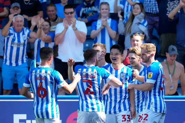 Yuta Nakayama #33 of Huddersfield Town celebrates his goal with team mates infant of the happy Town fans