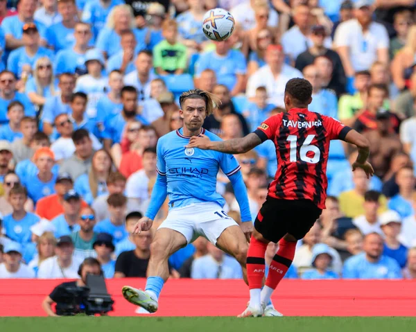 Marcus Tavernier #16 of Bournemouth is confronted by Jack Grealish #10 of Manchester City 