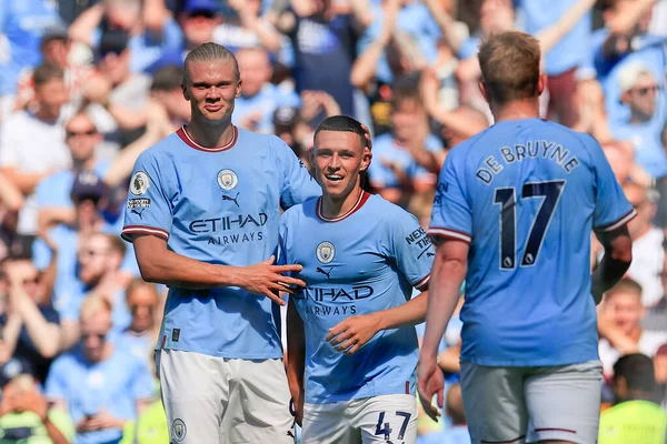 Erling Haaland #9 of Manchester City  congratulates Phil Foden #47 of Manchester City on scoring to make it 3-0