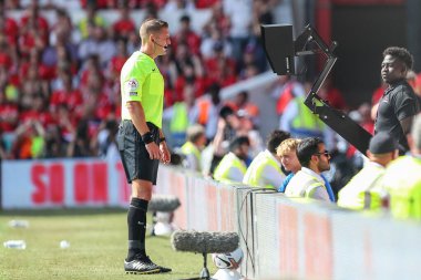 Referee Robert Jones goes to the VAR screen