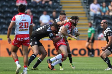 Alex Walmsley #8 of St Helens is tackled by Kane Evans #16 and Will Smith #40 of Hull FC