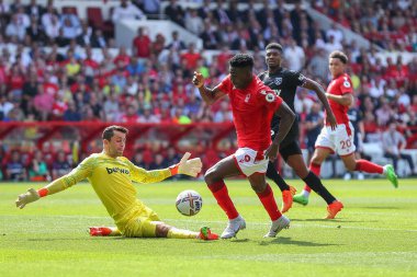 ukasz Fabiaski #1 of West Ham United tackles Taiwo Awoniyi #9 of Nottingham Forest  
