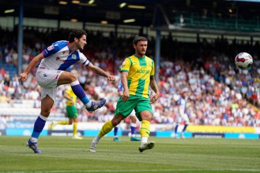 Lewis Travis #27 of Blackburn Rovers clears the ball under pressure from John Swift #19 of West Bromwich Albion 