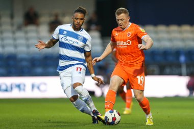 Shayne Lavery #19 of Blackpool on the ball under pressure from Tyler Roberts #11 of QPR 