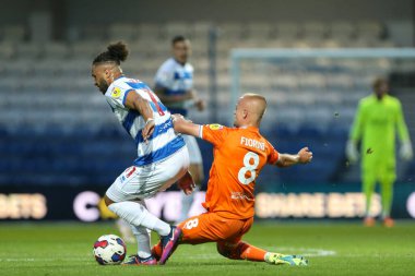 Lewis Fiorini #8 of Blackpool attempts to tackle Tyler Roberts #11 of QPR 