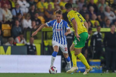 Pat Jones #26 of Huddersfield Town runs at Grant Hanley #5 of Norwich City