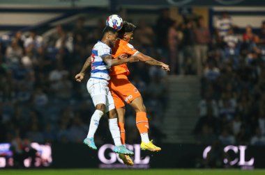 Jordan Lawrence-Gabriel #4 of Blackpool and Kenneth Paal #22 of QPR challenge for a header