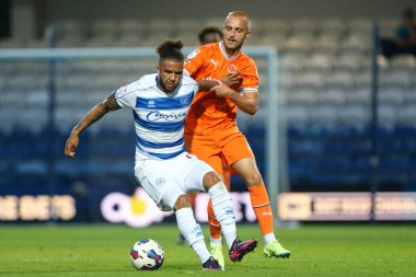 Lewis Fiorini #8 of Blackpool and Tyler Roberts #11 of QPR tussle for the ball