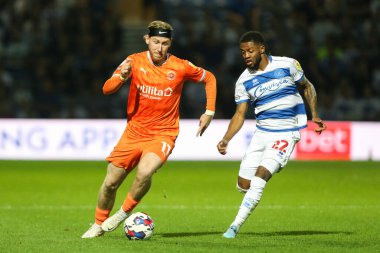 Josh Bowler #11 of Blackpool runs at Kenneth Paal #22 of QPR 