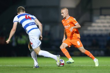 Lewis Fiorini #8 of Blackpool runs at Rob Dickie #4 of QPR 