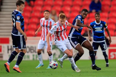 Anfernee Dijksteel #15 of Middlesbrough and Sam Clucas #7 of Stoke City challenge for the ball