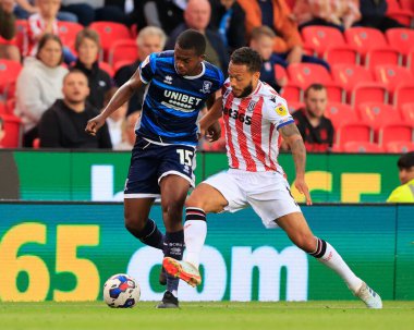 Anfernee Dijksteel #15 of Middlesbrough and Lewis Baker #8 of Stoke City challenge for the ball