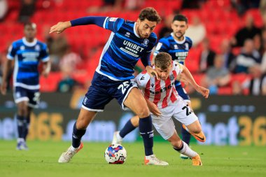 Matt Crooks #25 of Middlesbrough and Gavin Kilkenny #22 of Stoke City challenge for the ball