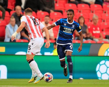 Isaiah Jones #2 of Middlesbrough is confronted by Jordan Thompson #15 of Stoke City