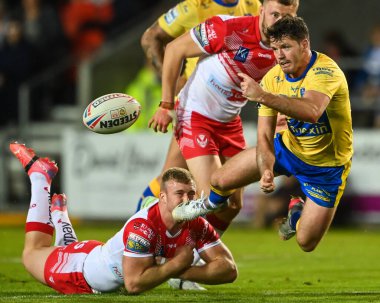 Lachlan Coote #1 of Hull KR is tackled by Joey Lussick #14 of St Helens