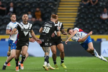 Ellis Longstaff #38 of Hull FC runs at Max Jowitt #1 of Wakefield Trinity leaving him in mid air