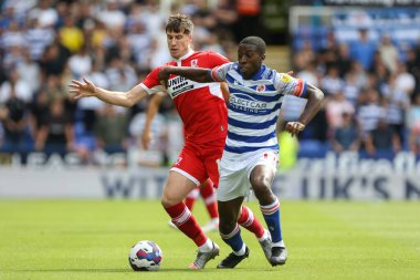 Paddy McNair #17 of Middlesbrough puts Junior Hoilett #23 of Reading under pressure