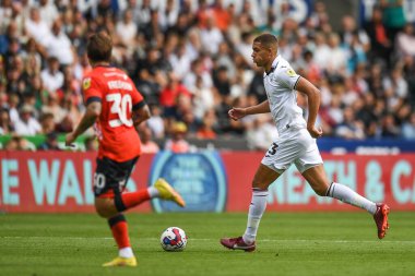 Nathan Wood #23 of Swansea City takes on Luke Freeman #30 of Luton Town 